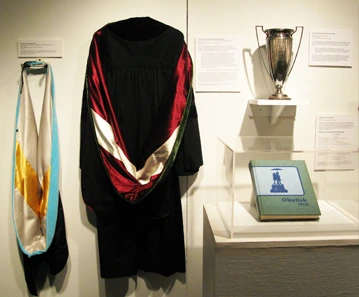 Exhibit display showing a graduation gown worn by Dr. Sliepcevich 