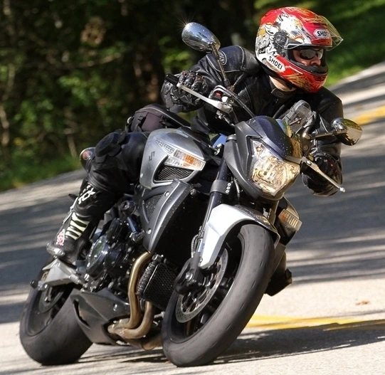 Student riding a motorcycle with helmet